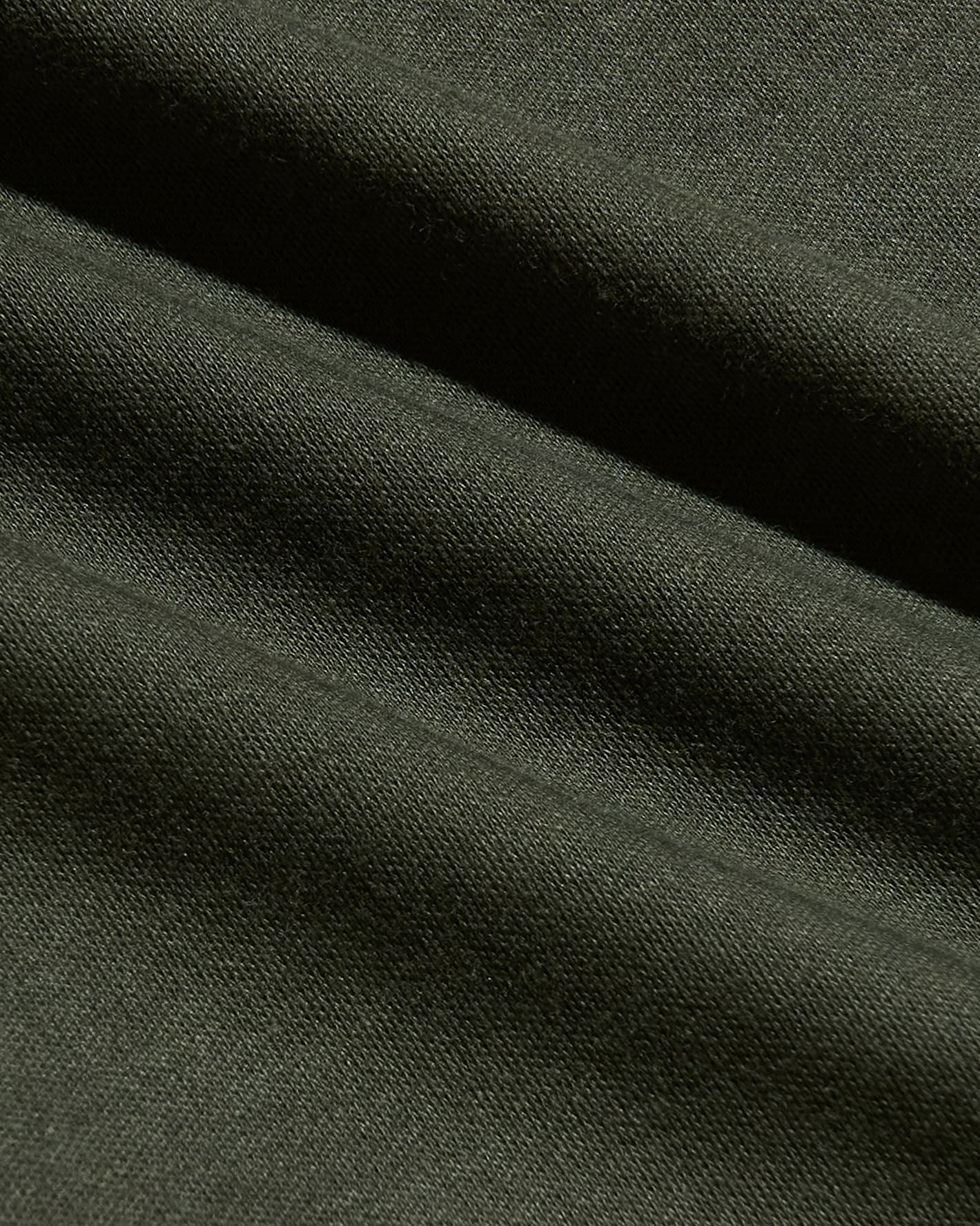 Close-up of soft dark green fabric texture from the Grove Tall Pima Cotton Blend Curved Hem Crew, showcasing quality men's basics material with a smooth, comfortable finish.