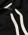 Black Tall Fleece Pullover Hoodie hood with cream drawcords and label.