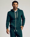 Man wearing Emerald Fleece French Terry Zip Hoodie with matching sweatpants.