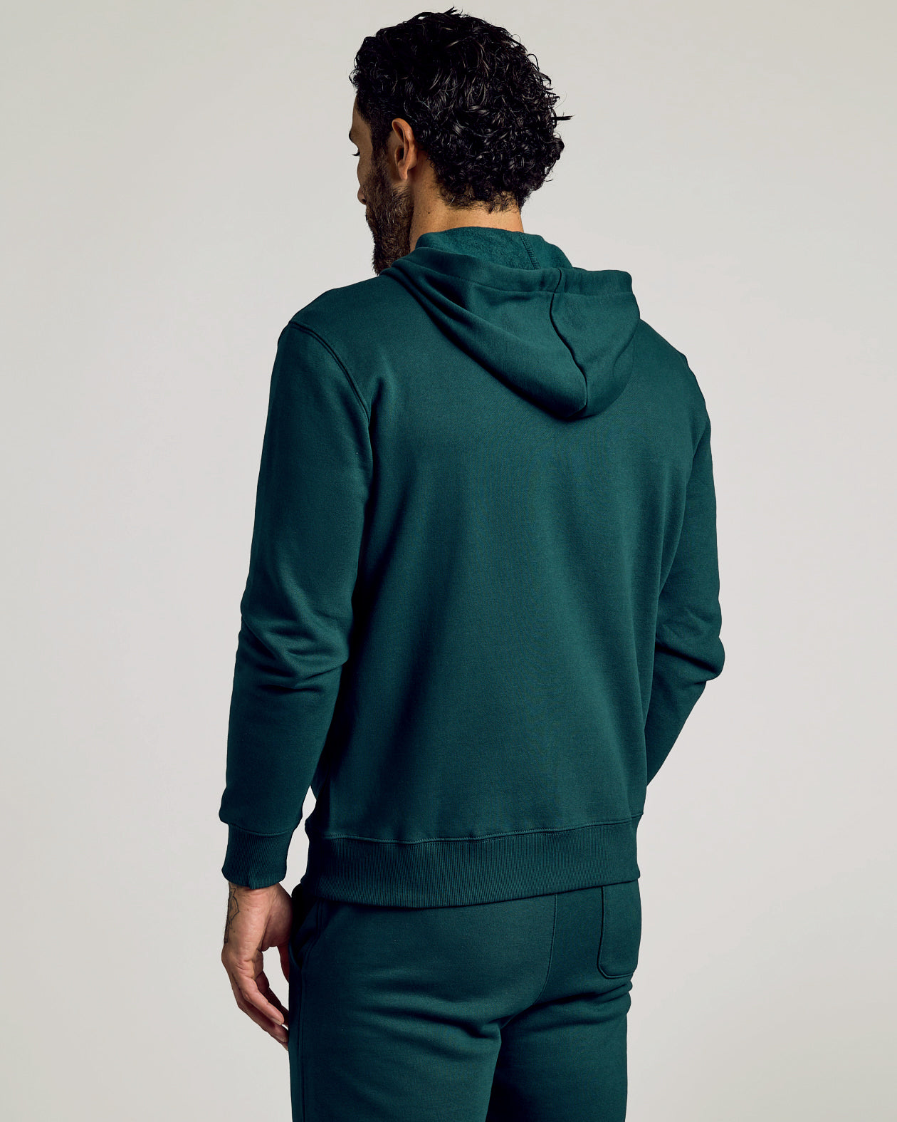 Back view of man in Emerald Fleece French Terry Zip Hoodie.