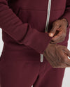 Adjusting the cuff of Mahogany Fleece French Terry Zip Hoodie.