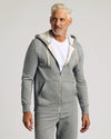 Man wearing Dark Heather Gray Fleece French Terry Zip Hoodie with sweatpants.