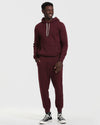 Man models Mahogany Fleece French Terry Pullover Hoodie with matching joggers.