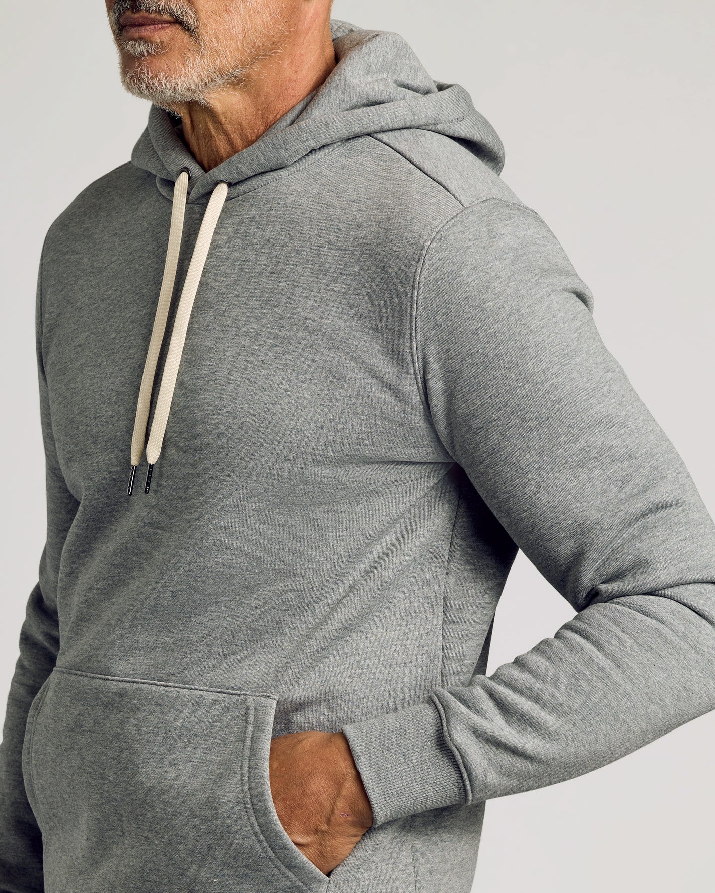 Man wearing Dark Heather Gray Fleece French Terry Pullover Hoodie.