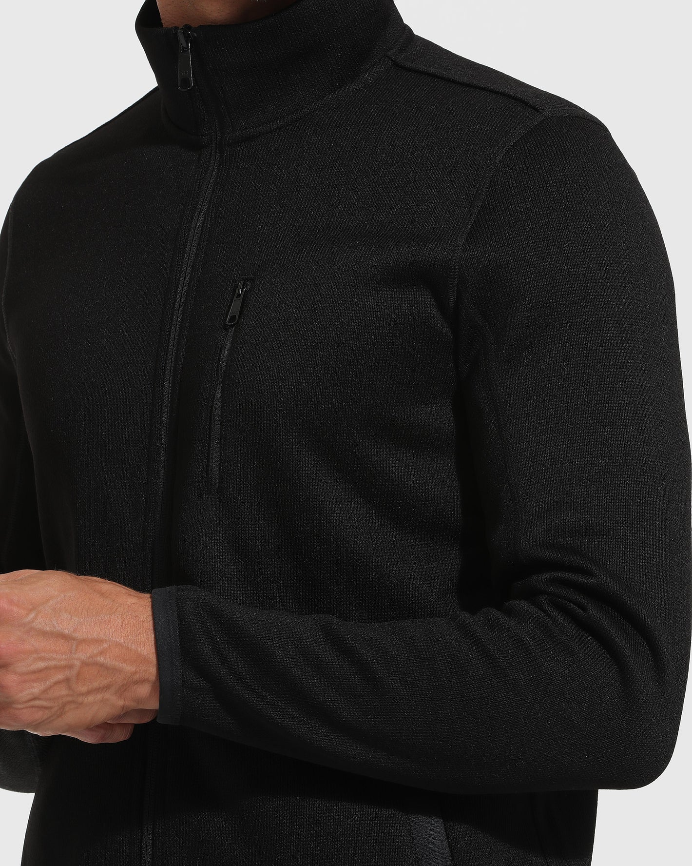 Black Sweater Fleece Jacket with zippered chest pocket and high collar.