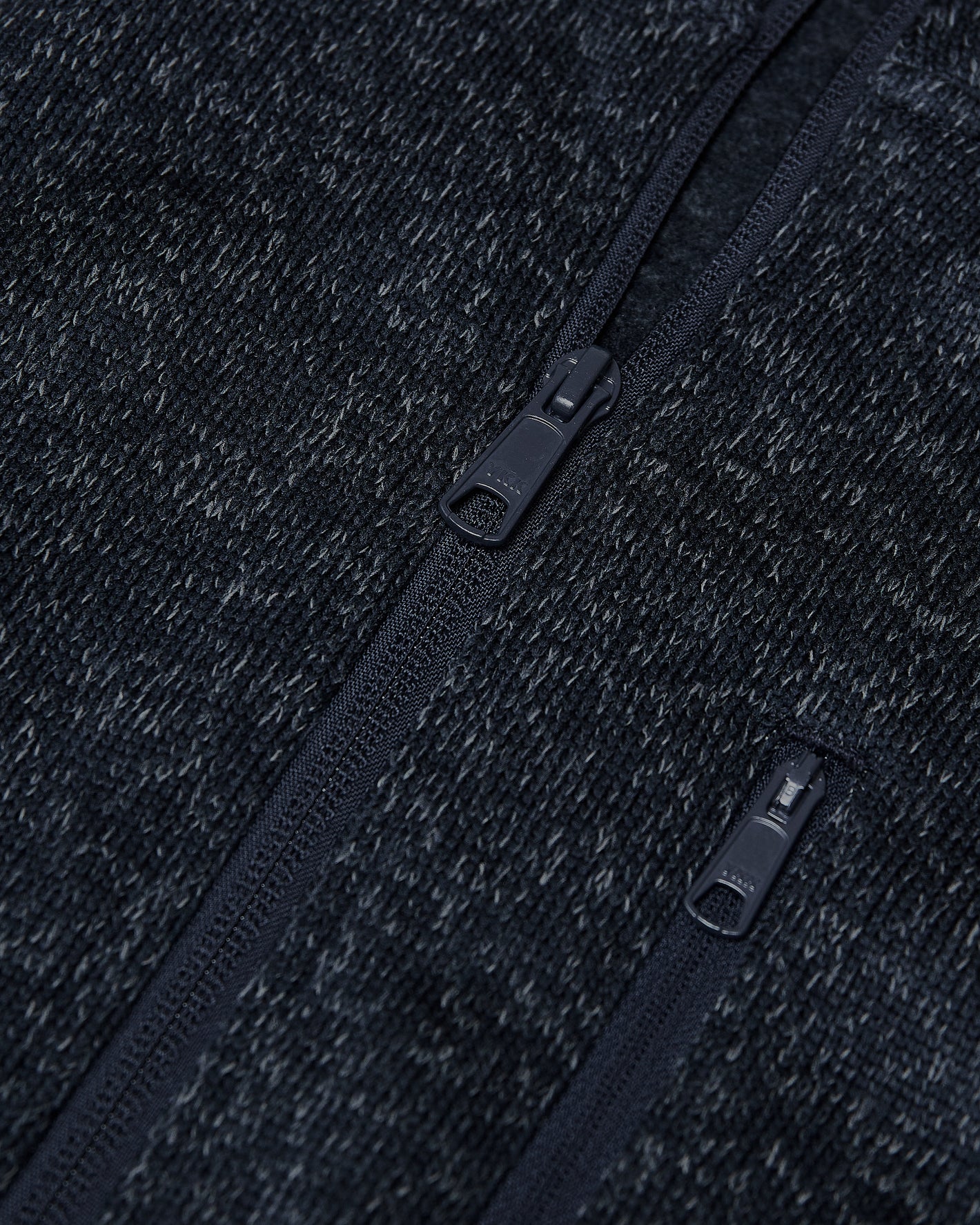 Navy Sweater Fleece Jacket with detailed zippers and textured knit fabric.