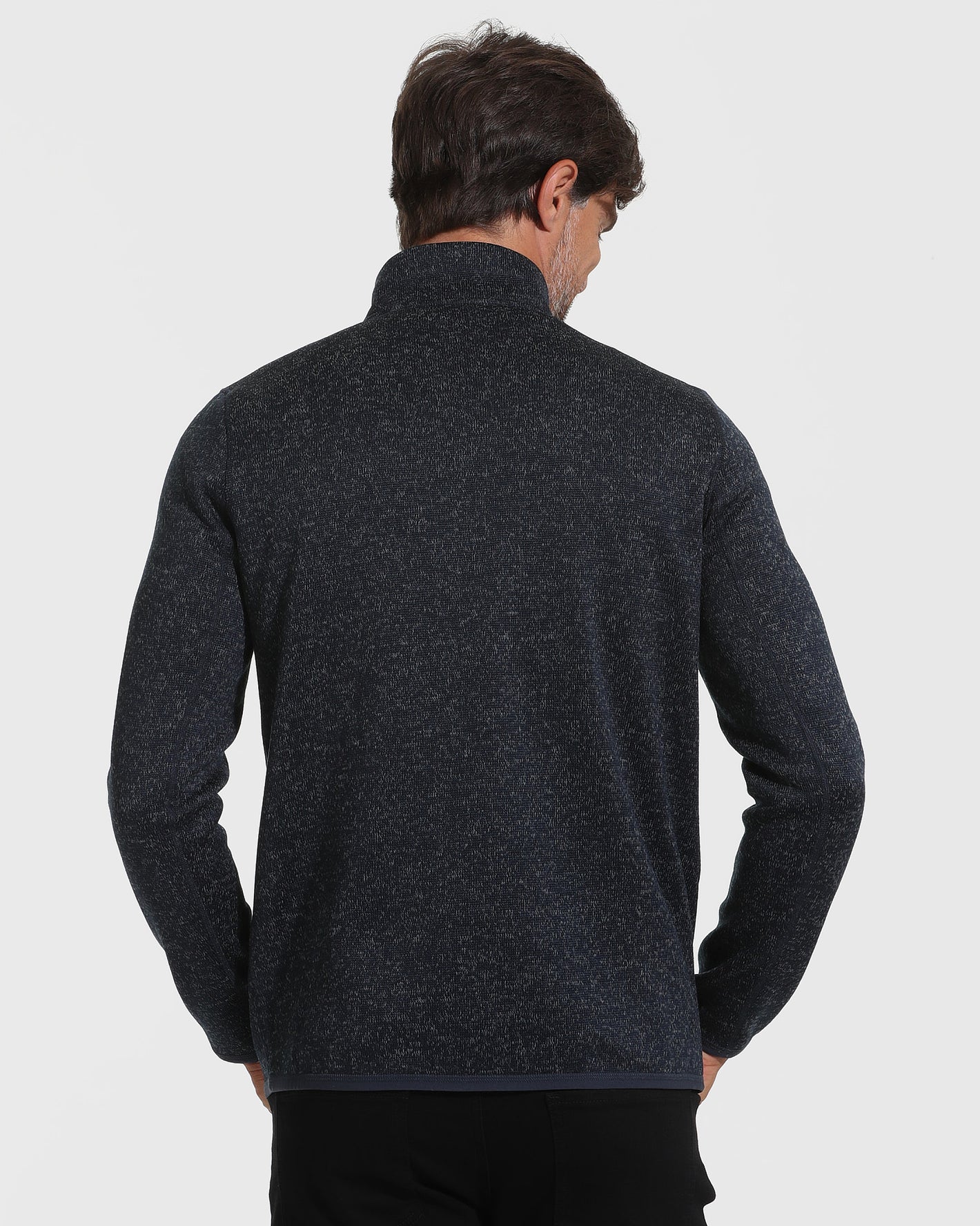 Man wearing Navy Sweater Fleece Jacket, back view, hands at sides.