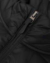 Black Puffer Jacket zipper on quilted fabric, showcasing stitching detail.