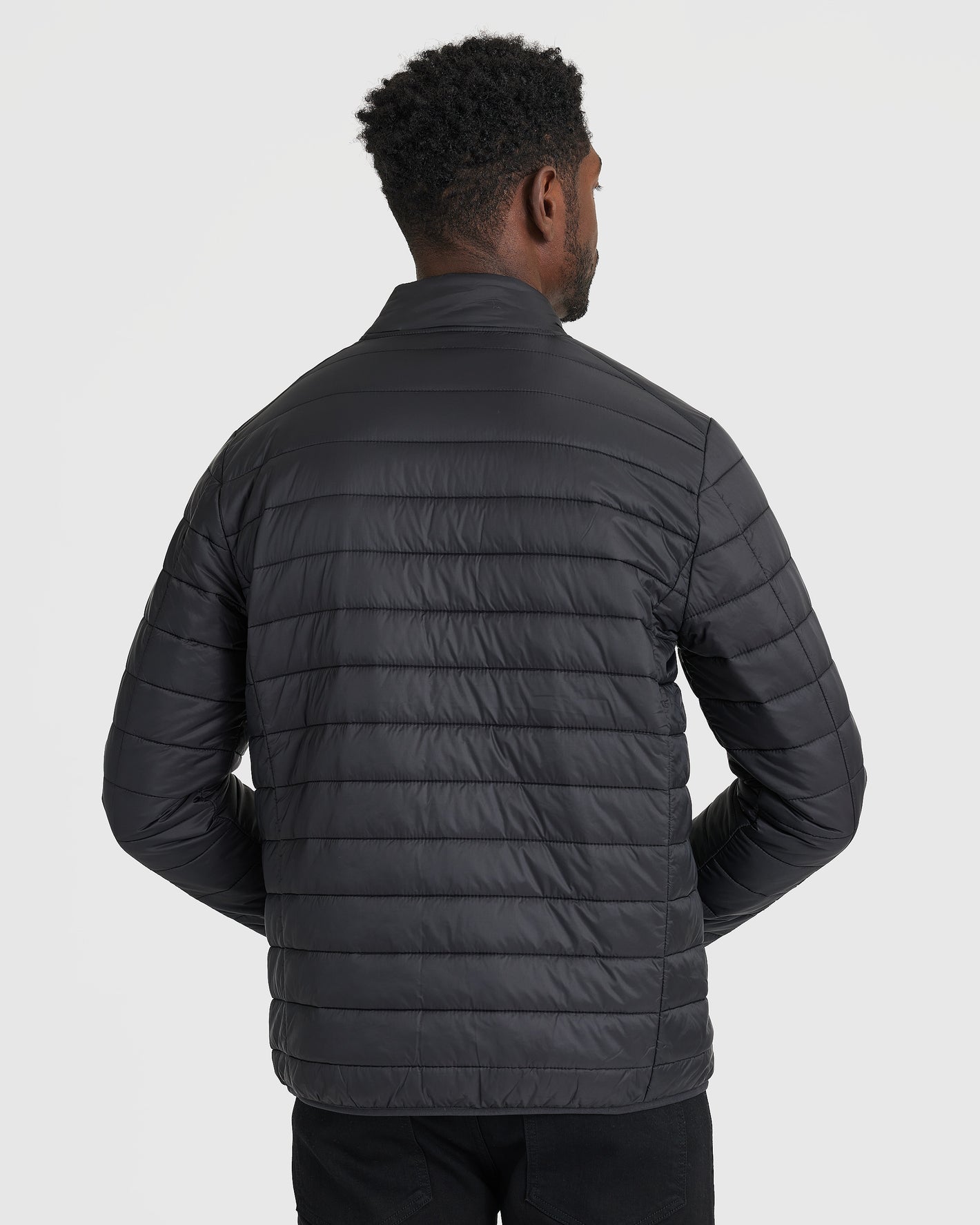 Black Puffer Jacket, back view, quilted with horizontal stitching, simple collar.