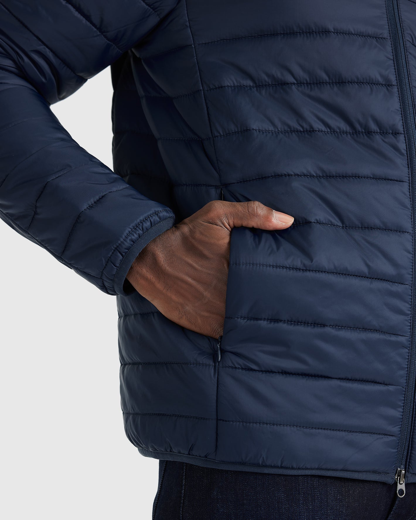 Navy Puffer Jacket with quilted design and zippered side pocket.