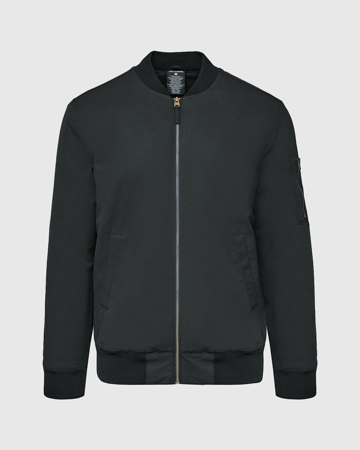 Black Bomber Jacket with brass zippers and orange lining.