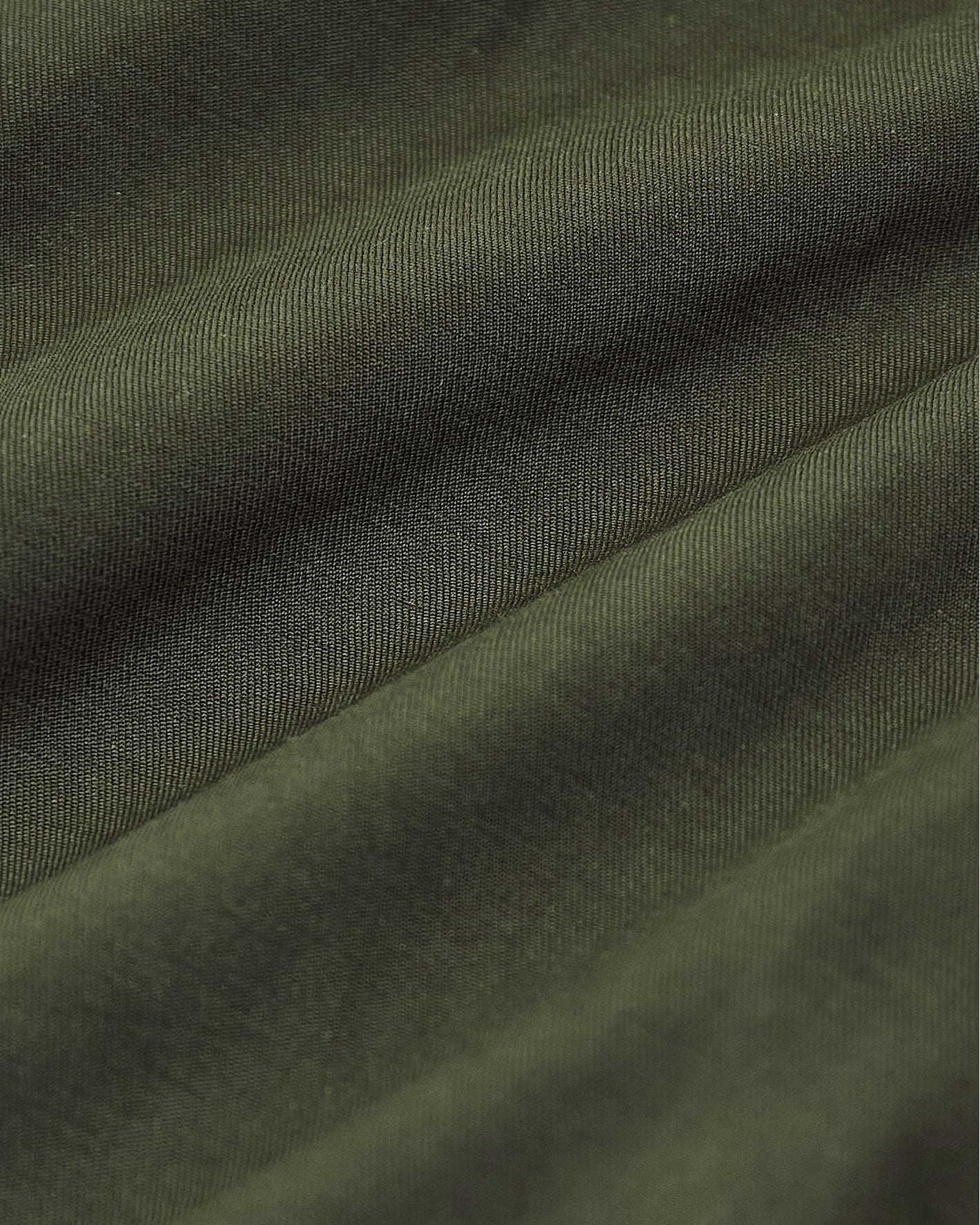 Army Green Bomber Jacket close-up, showcasing fine weave and soft drape.