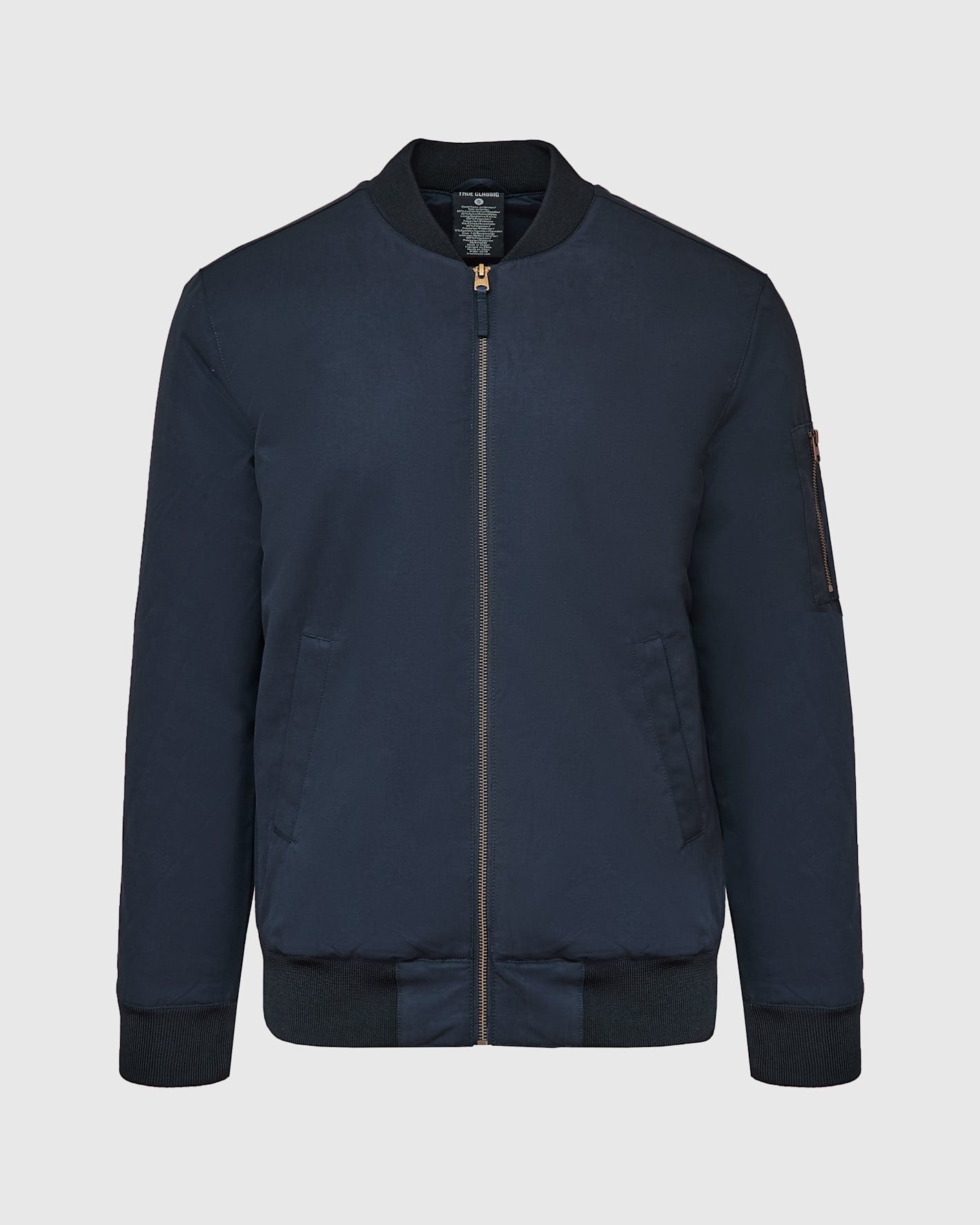 Navy Bomber Jacket with brass zip and rib-knit details.