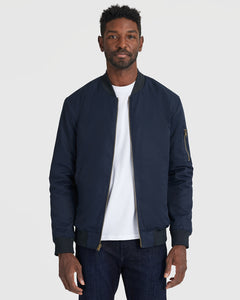 True ClassicNavy Bomber Jacket on man, featuring zippered sleeve pocket.