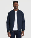 Navy Bomber Jacket on man, featuring zippered sleeve pocket.