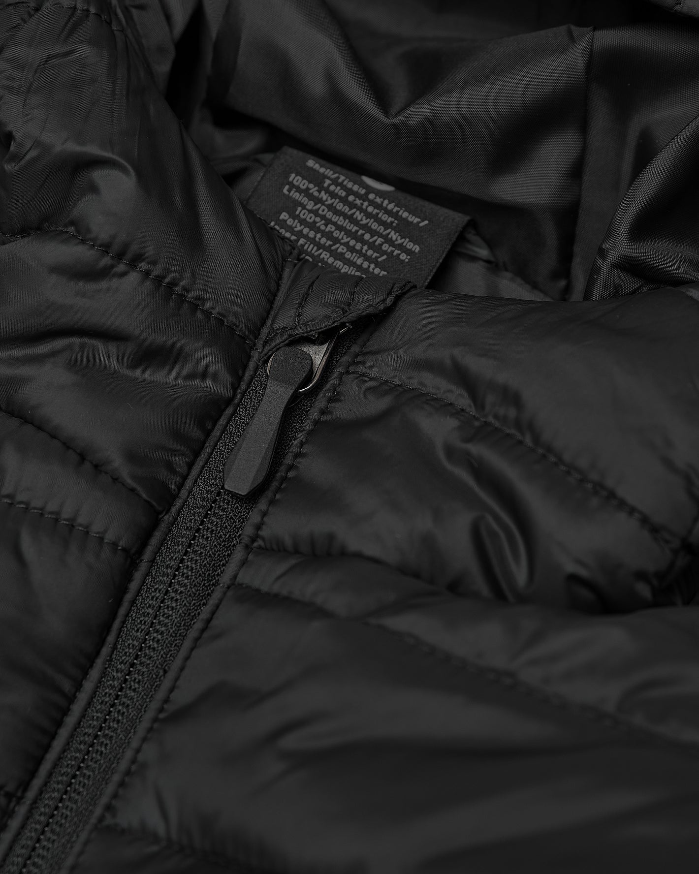 Black Hooded Puffer Jacket with quilted design, central zipper, and fabric label.