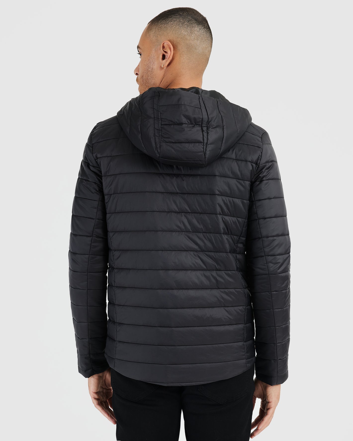 Black Hooded Puffer Jacket, back view, showcasing quilt stitching and hood.