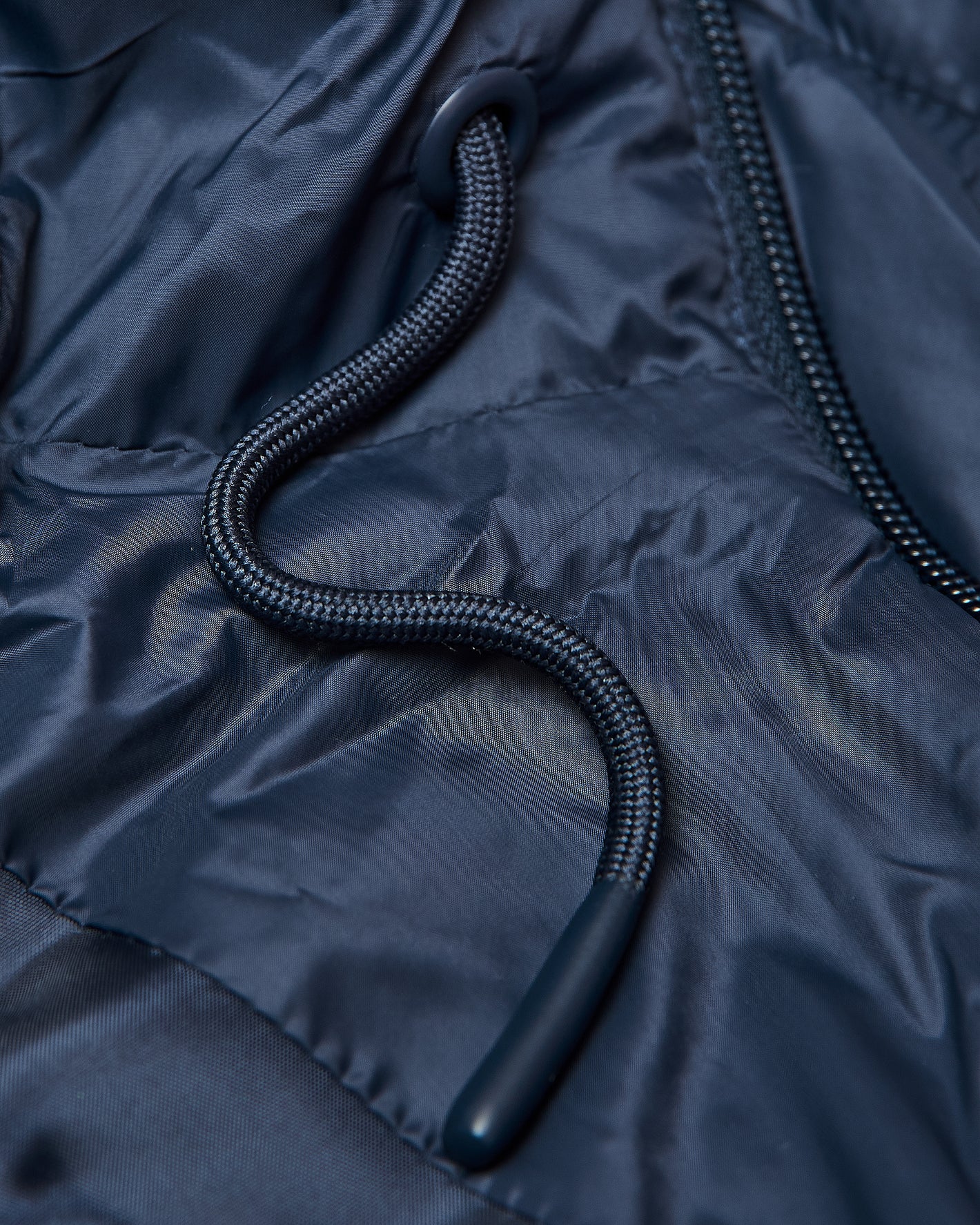 Navy Hooded Puffer Jacket with zipper, grommet, and braided drawstring.
