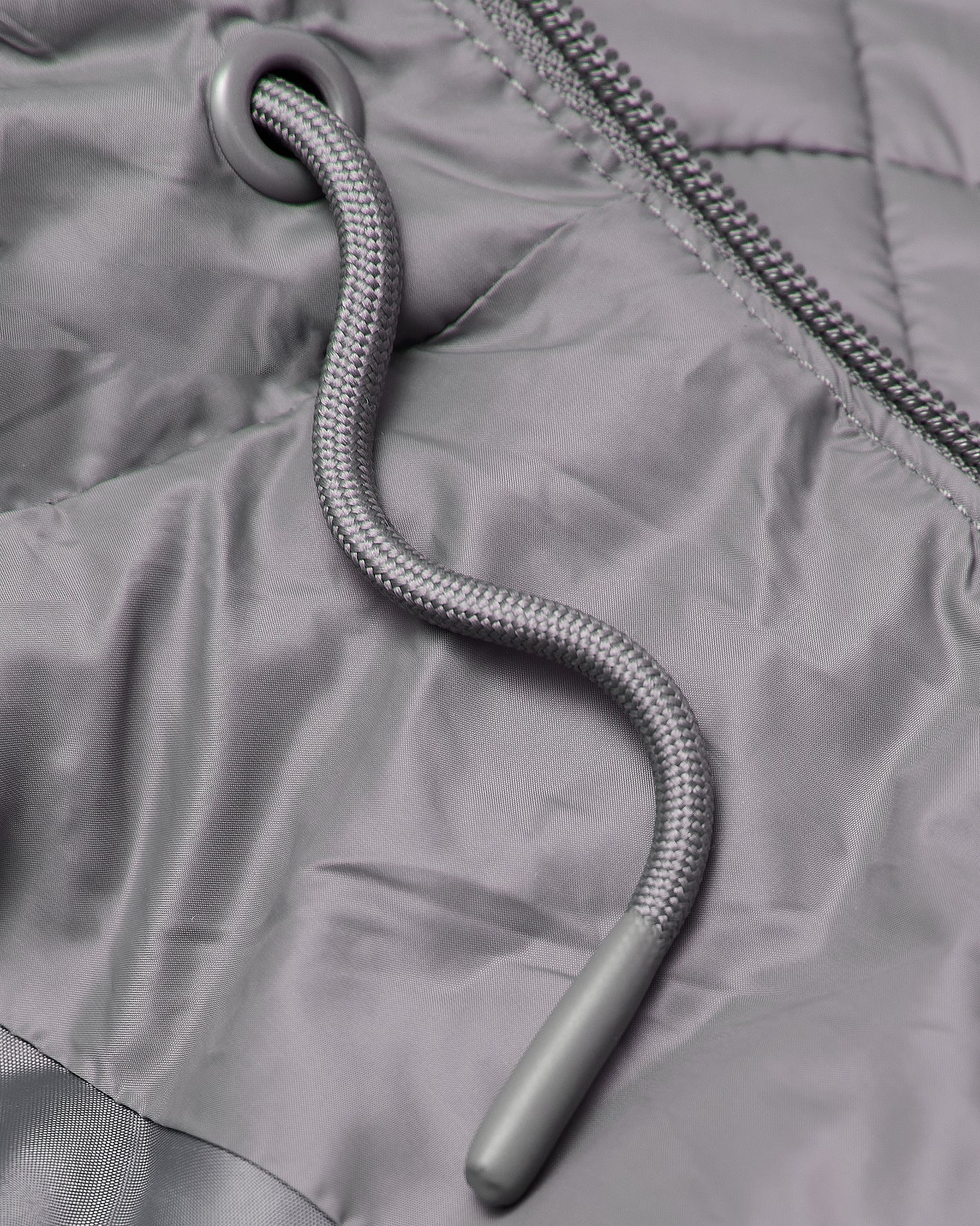 Gunmetal Hooded Puffer Jacket with quilted stitching and braided drawcord.