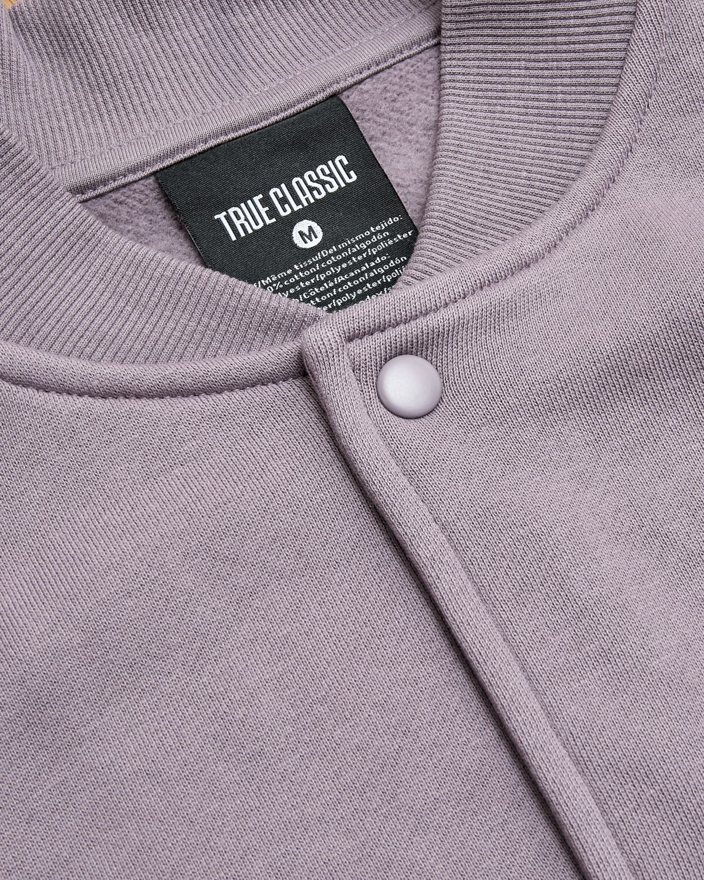 Thistle Fleece Bomber Jacket with snap-front, rib texture, and TRUE CLASSIC label.