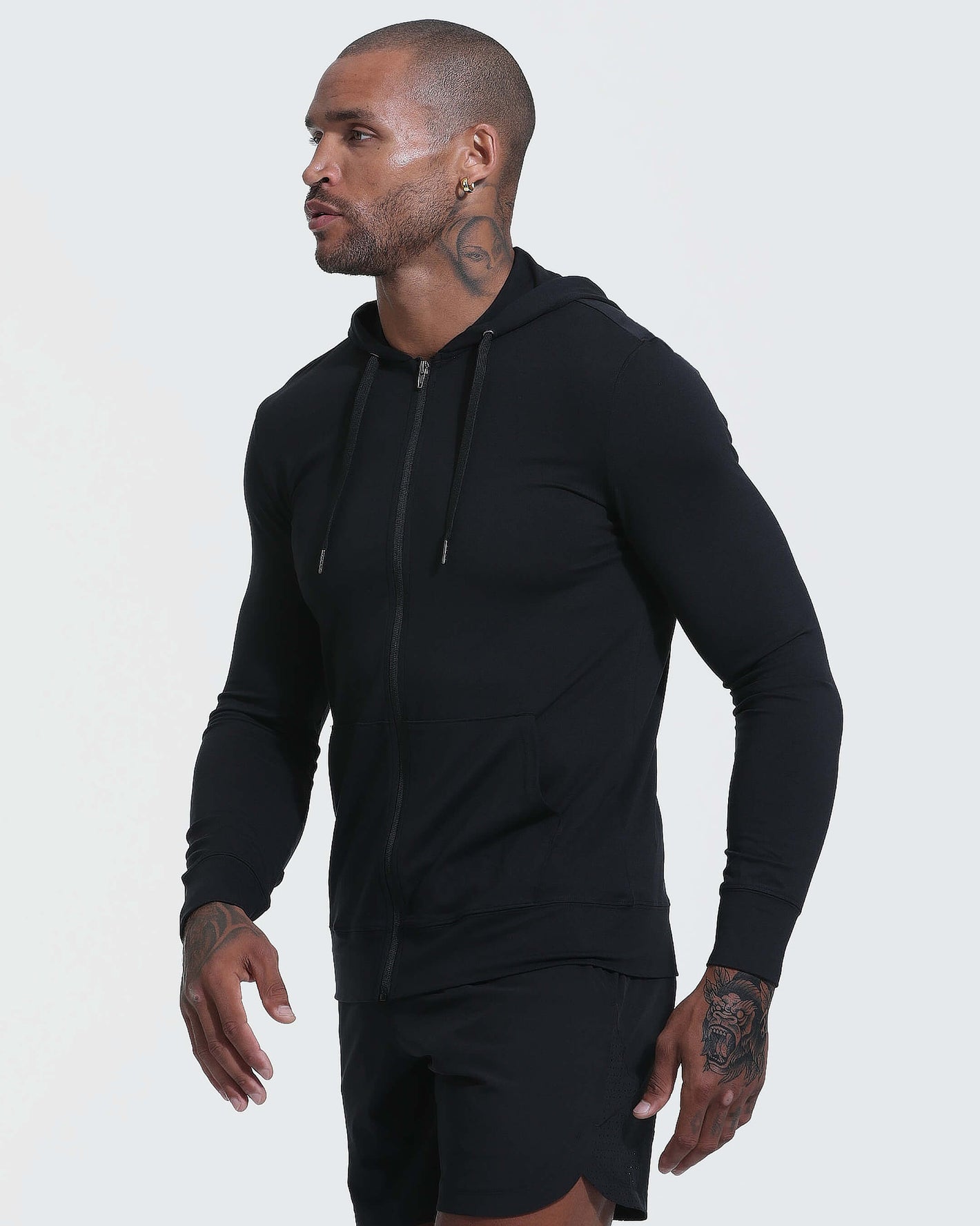 Model in Black Active Comfort Full Zip Hoodie and black shorts.