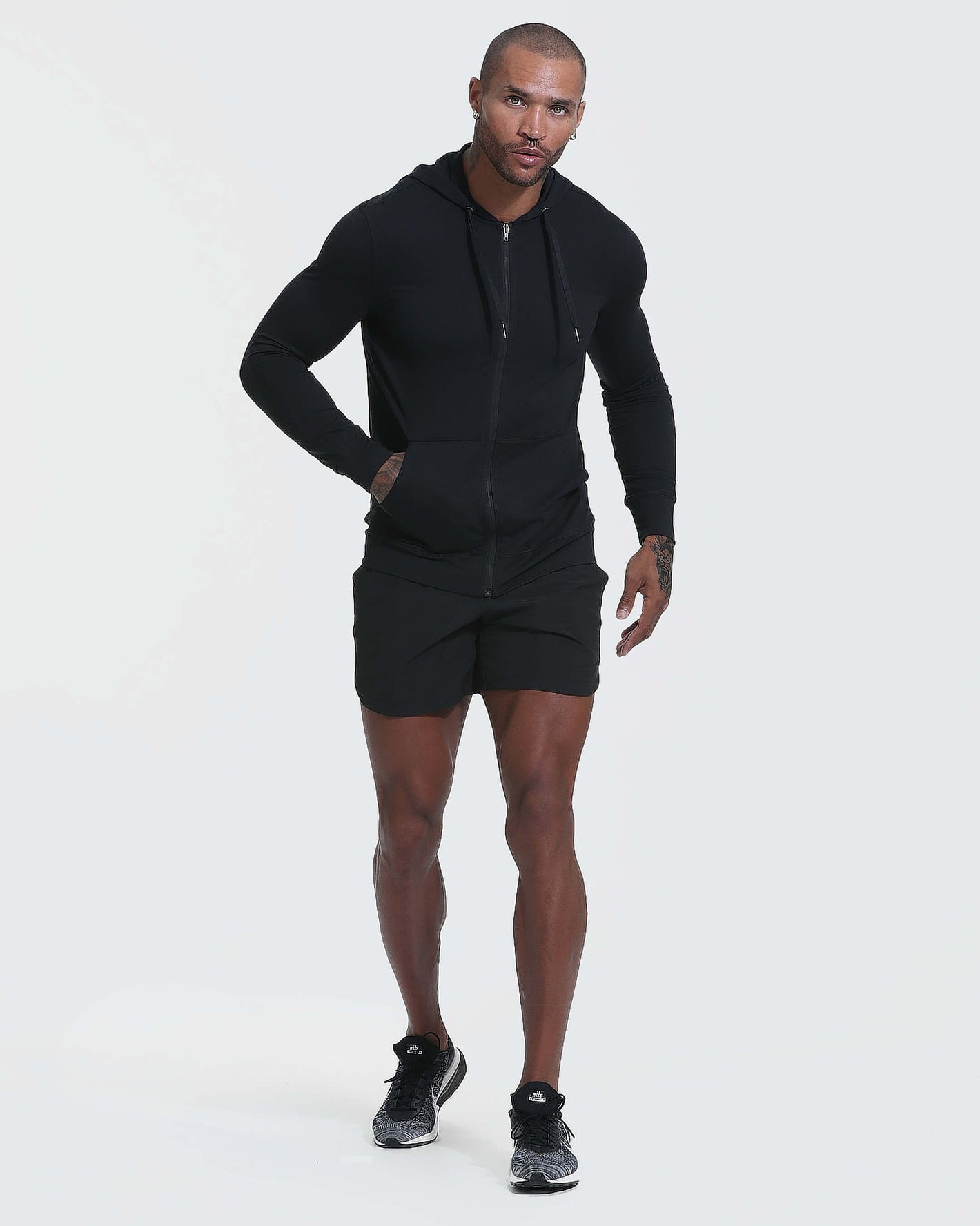 Person in Black Active Comfort Full Zip Hoodie mid-stride.