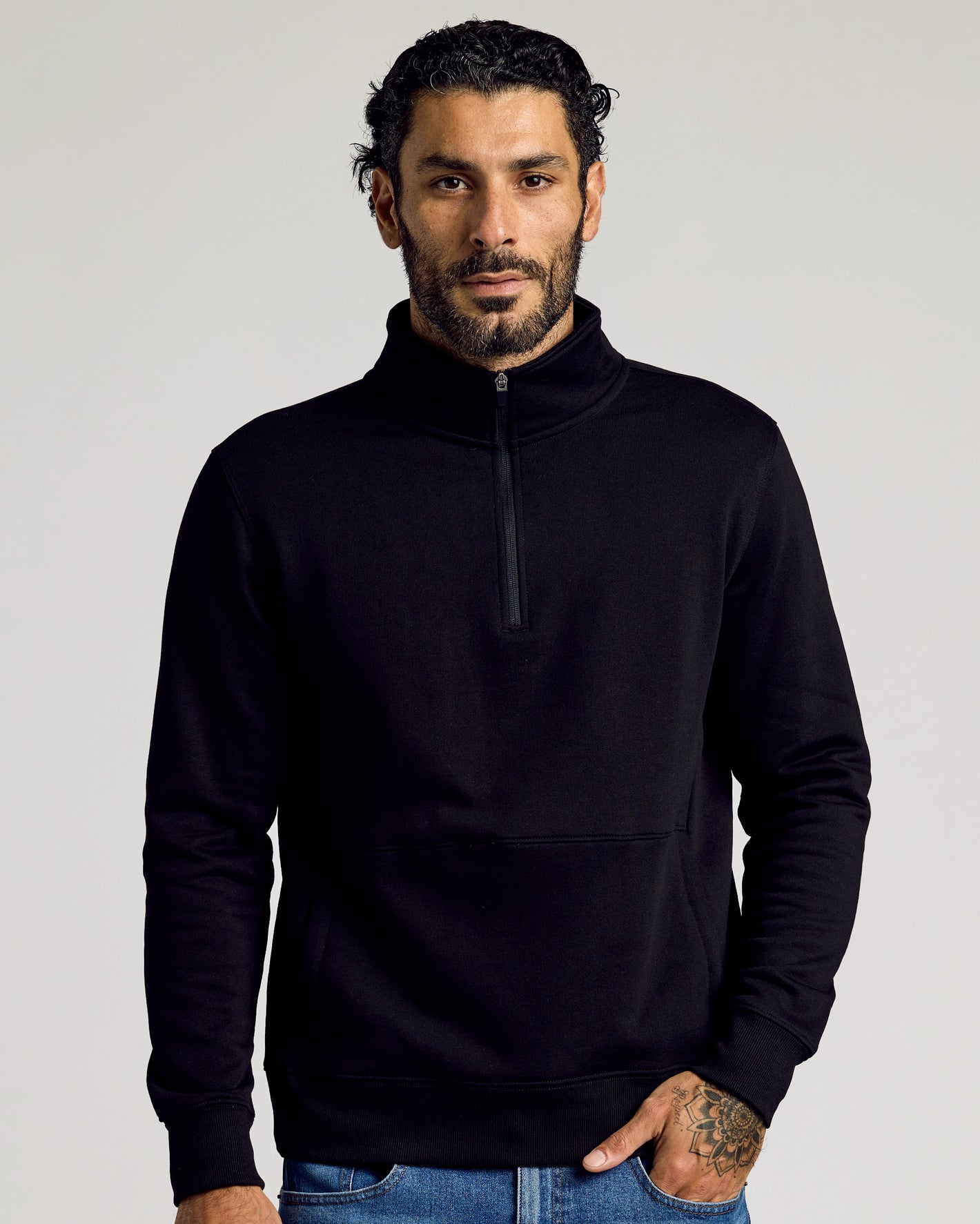 Man wearing The Fleece Fit 3-Pack's black quarter-zip pullover.