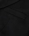 Black Comfort Knit Blazer showing a neatly sewn welt pocket.