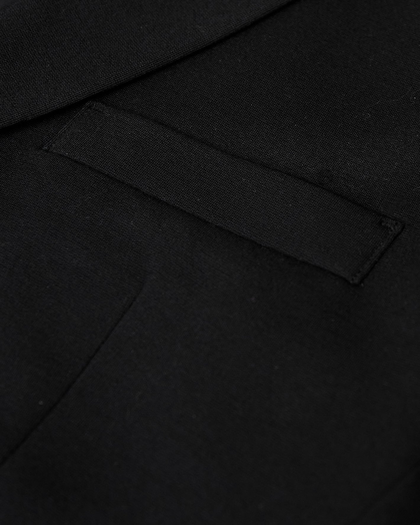 Black Comfort Knit Blazer showing a neatly sewn welt pocket.
