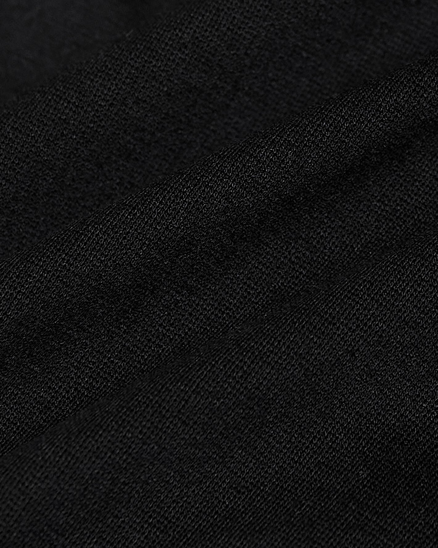 Black Comfort Knit Blazer fabric close-up showing texture and fine weave.