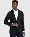 Man wearing Black Comfort Knit Blazer, ready to fasten button.