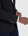Adjusting cuff of Black Comfort Knit Blazer under a black blazer.