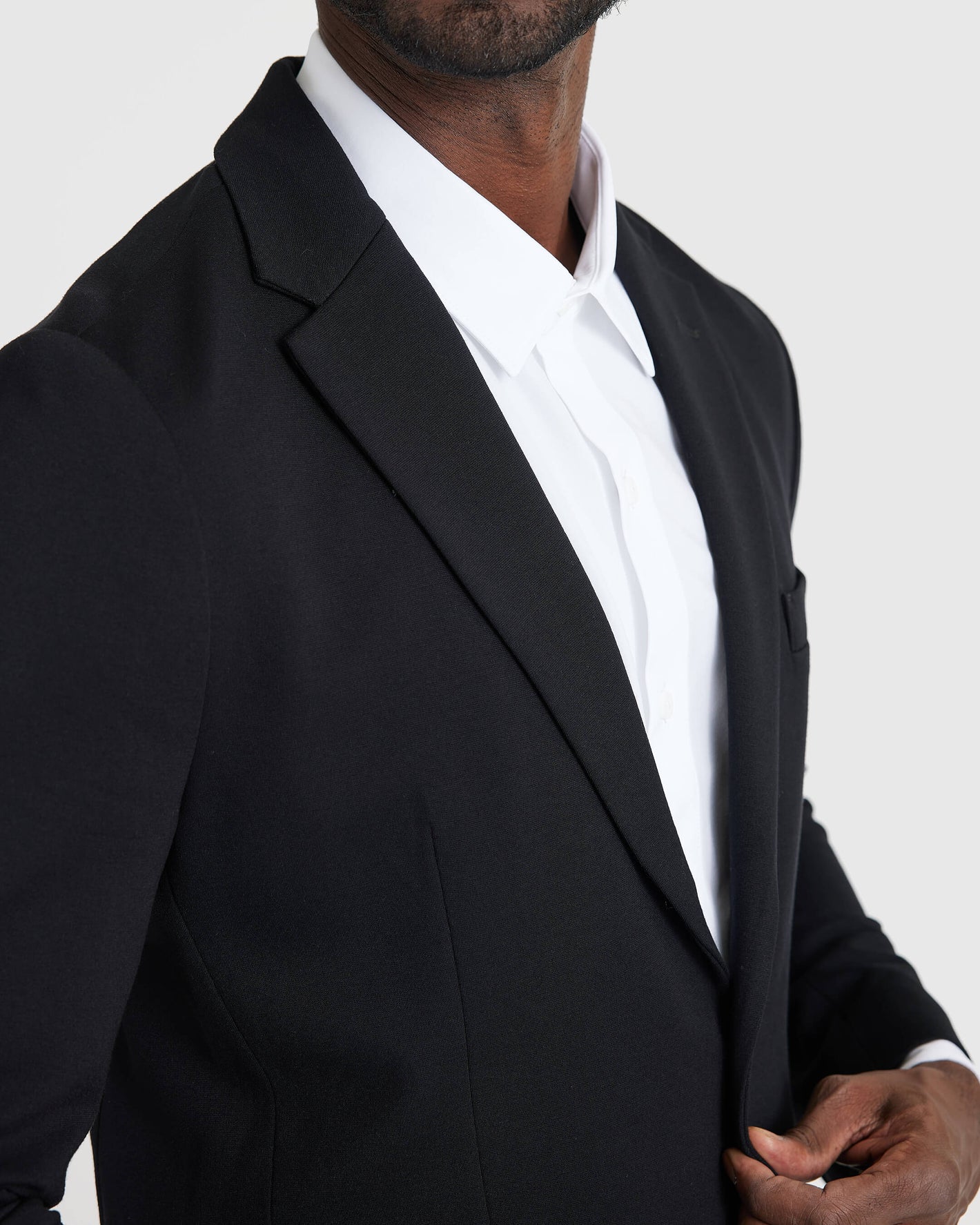 Black Comfort Knit Blazer worn by a man, showcasing fit and style.