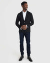 Man wearing Black Comfort Knit Blazer with jeans and Chelsea boots.