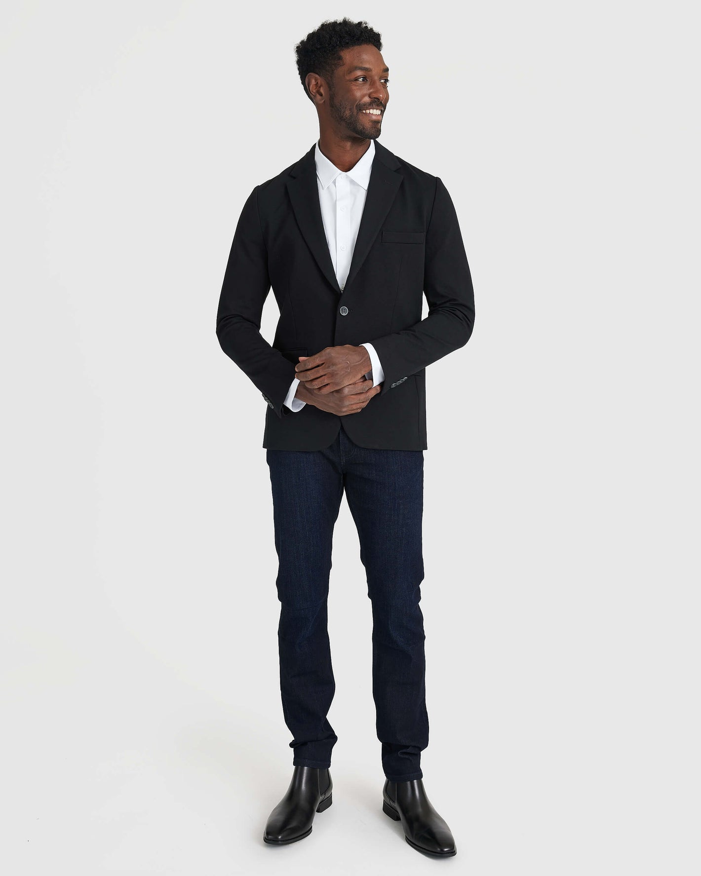 Man wearing Black Comfort Knit Blazer with jeans and Chelsea boots.