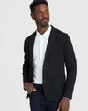 Man wearing Black Comfort Knit Blazer over white shirt with jeans.