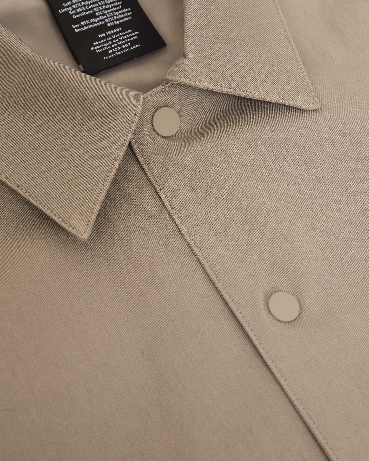 Khaki Coaches Jacket with snap buttons, pointed collar, label visible.