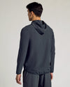 Man wearing Charcoal Heather Gray Active Shell Jacket, hood down, back view.