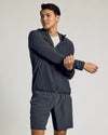 Young man stretches in Charcoal Heather Gray Active Shell Jacket.