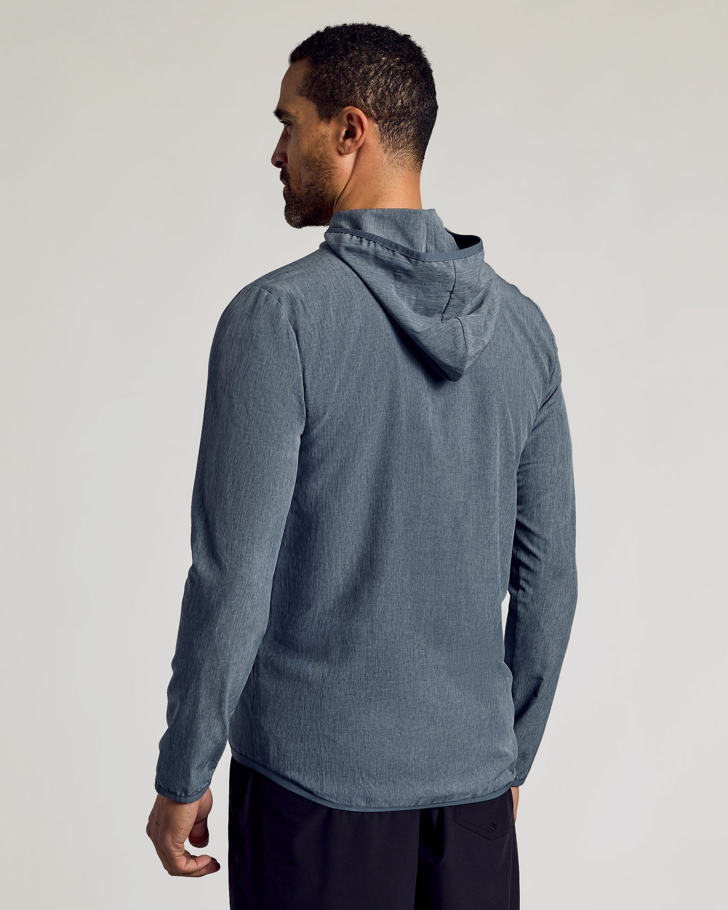 Heather Navy Active Shell Jacket worn by man, side view.