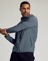 Man stretching in Heather Navy Active Shell Jacket.