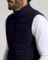 Black Puffer Vest over white shirt, highlighting quilted design and zipper.