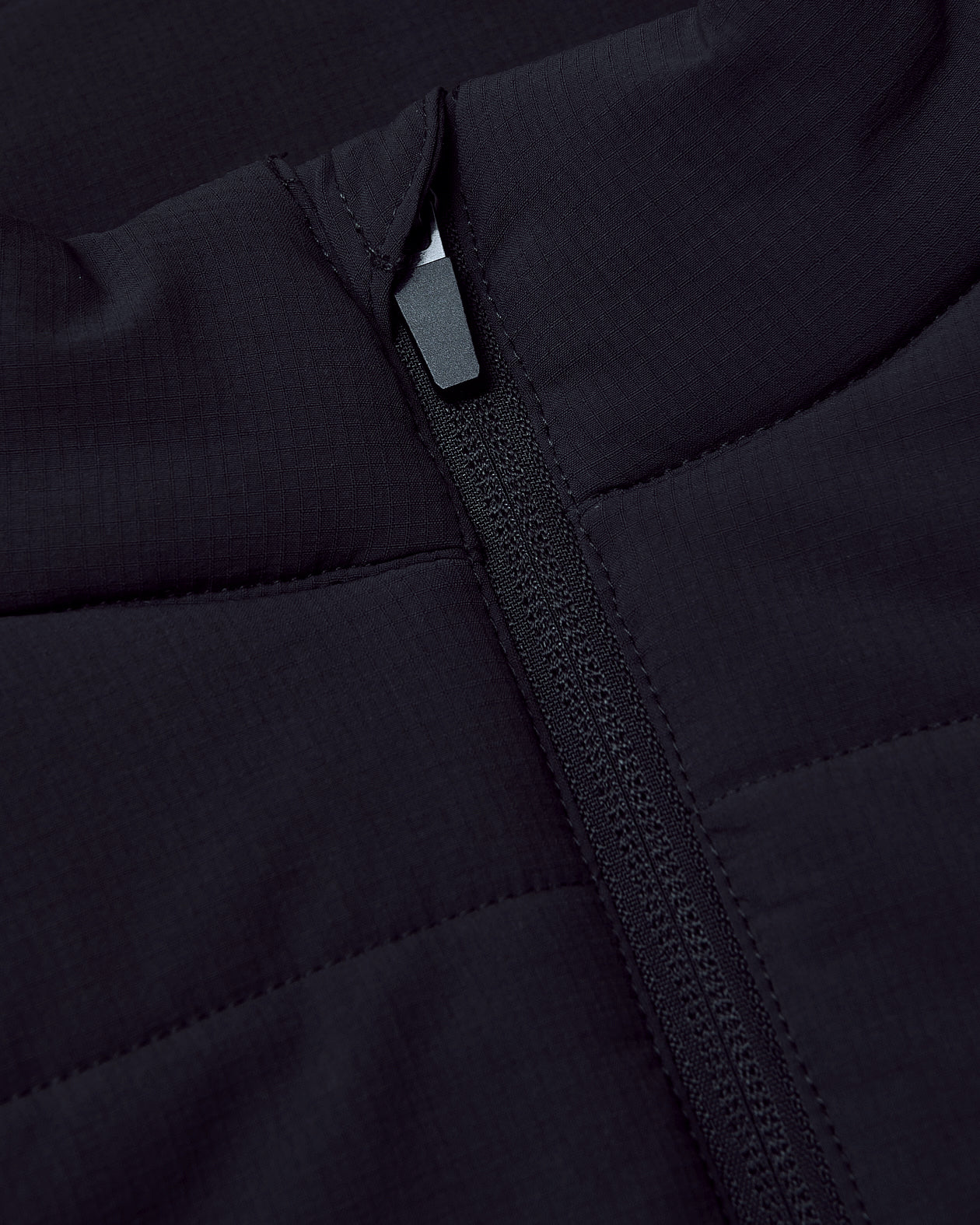 Black Puffer Vest with central zipper and quilted design.