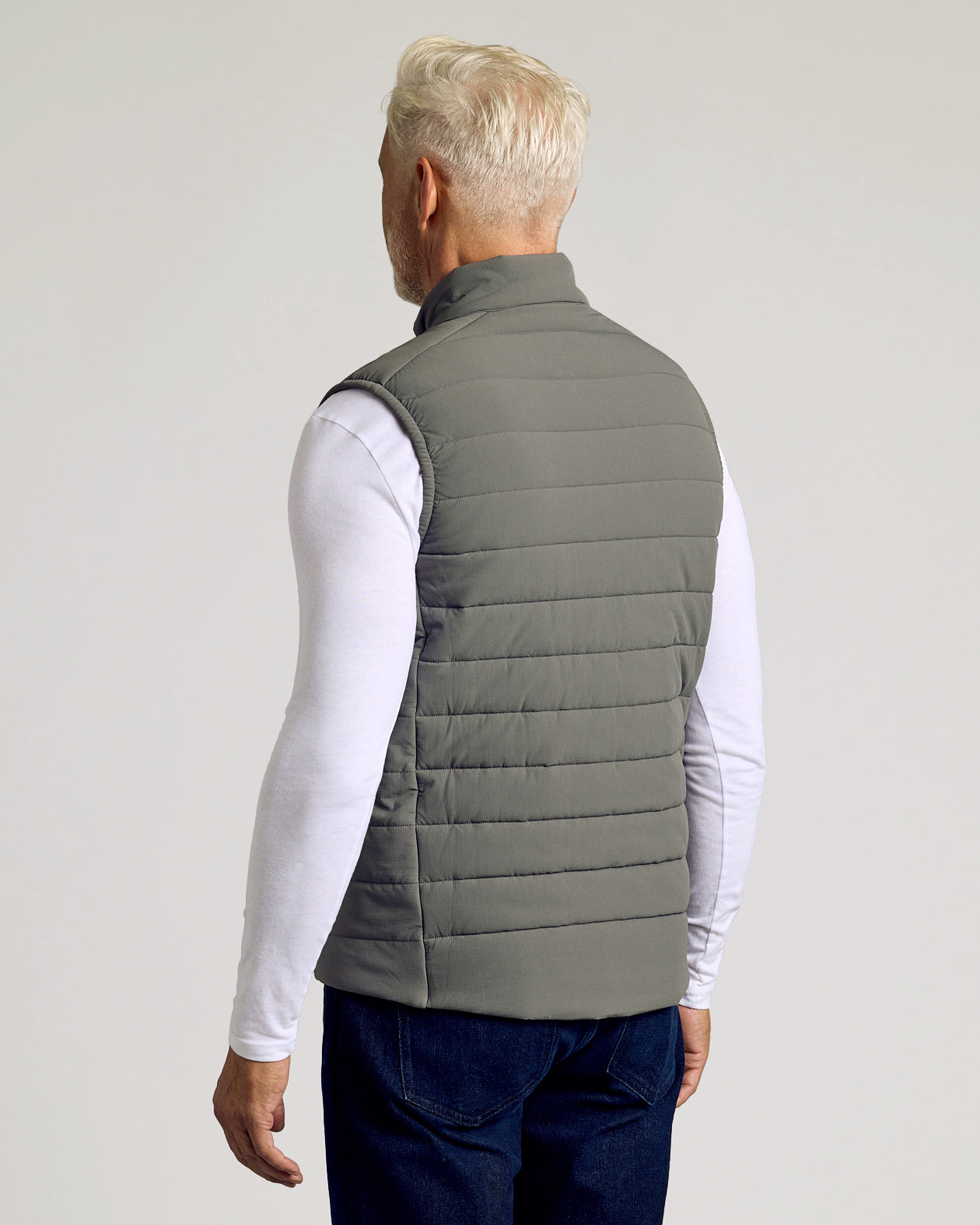 Carbon Puffer Vest, back view on model; snug fit, sleek design.