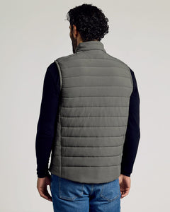 True ClassicMan wearing a gray Carbon Puffer Vest over a black long-sleeve shirt and blue jeans, shown from the back against a neutral background.