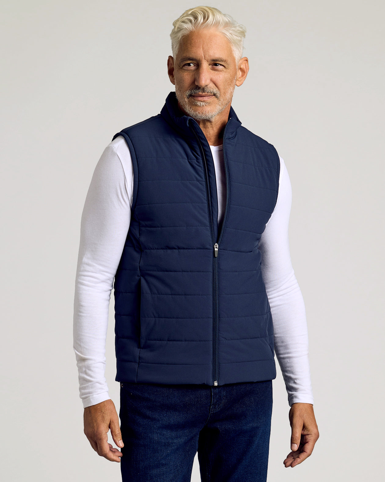 Navy Puffer Vest on middle-aged man over white T-shirt.