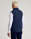 Man wearing Navy Puffer Vest over long-sleeve T-shirt and jeans.