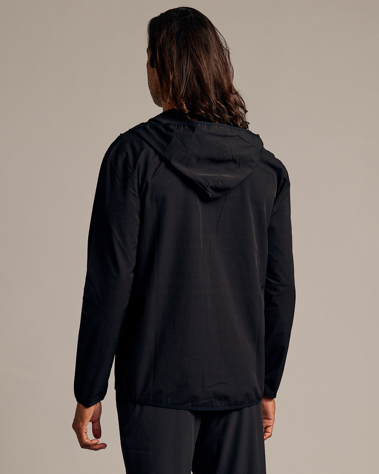 Black Tech Windbreaker shown from the back, hood down.