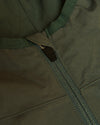 Olive Tech Windbreaker close-up, highlighting front zipper and stitched panels.