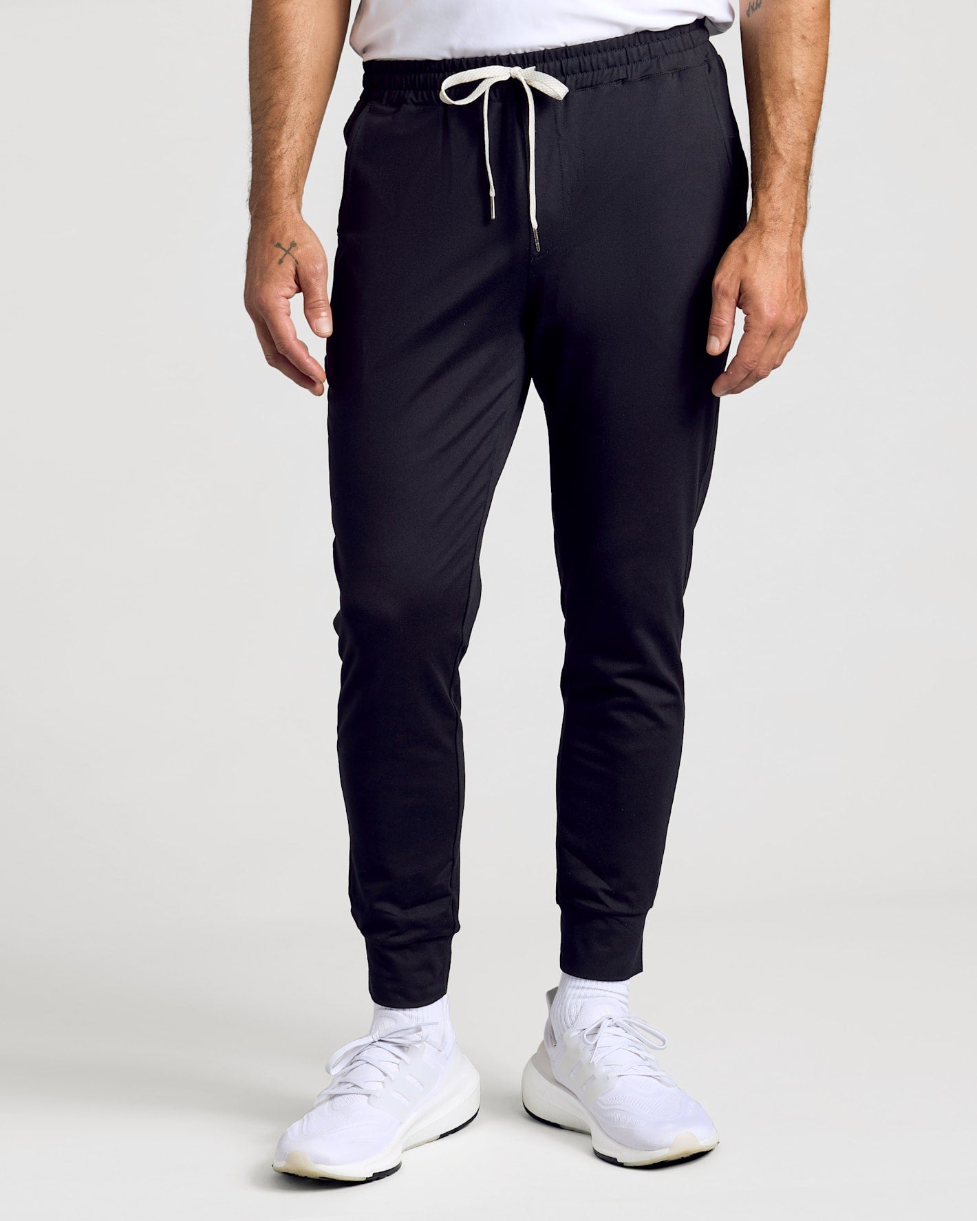 Model wearing All Black Active Joggers with elastic waistband, white drawstring.